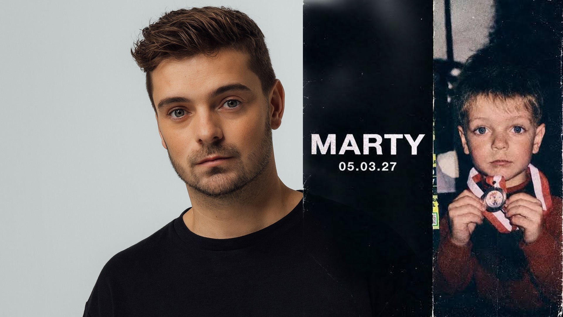 Мартин Гаррикс в чёрной футболке рядом с тёмной панелью с надписью «MARTY 05.03.27» и старым фото юного Мартина Гаррикса с медалью.