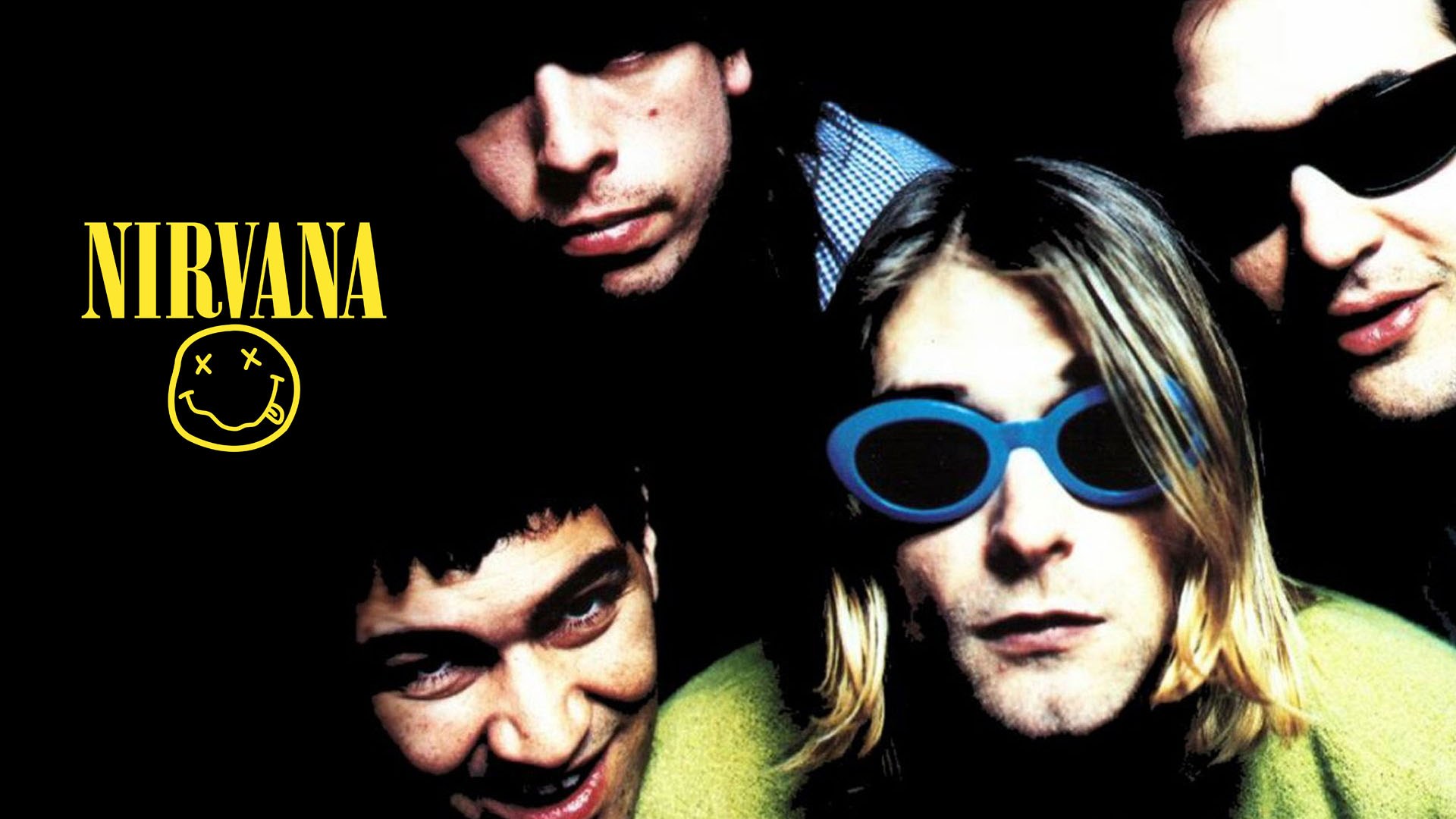 Les membres de Nirvana avec un style grunge sur fond noir, l'un portant des lunettes ovales bleues et un cardigan vert.